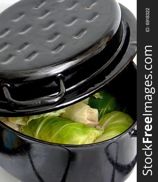 Close up of the tasty stuffed cabbage in black baking tin.