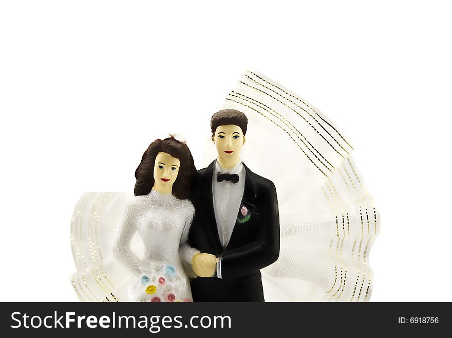 Figures of a newly-married couple on a white background