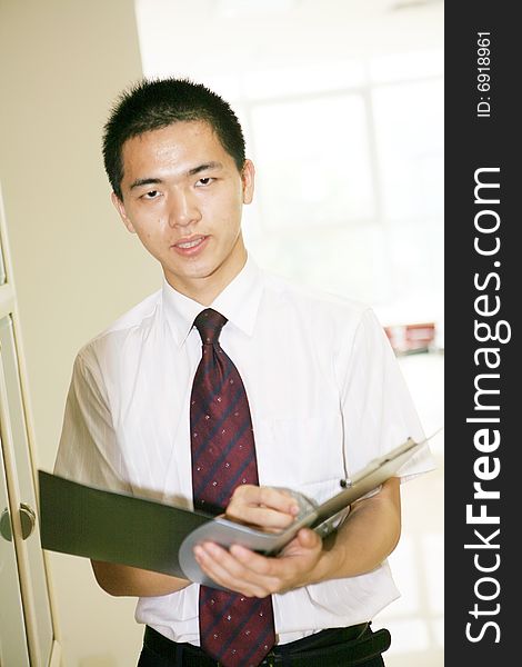 A young asian working in office