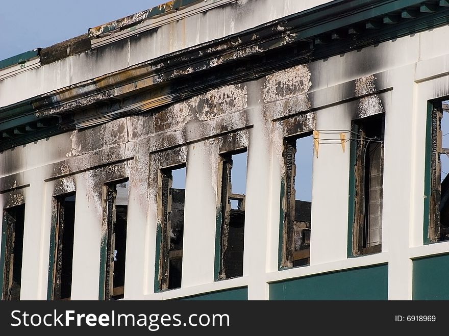 Charred remains of a fire damaged restaurant. Burnt char and soot with signs of smoke damage. Charred remains of a fire damaged restaurant. Burnt char and soot with signs of smoke damage.