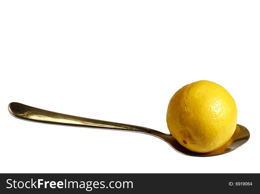 A yellow lemon on a spoon isolated on white with clipping path. A yellow lemon on a spoon isolated on white with clipping path
