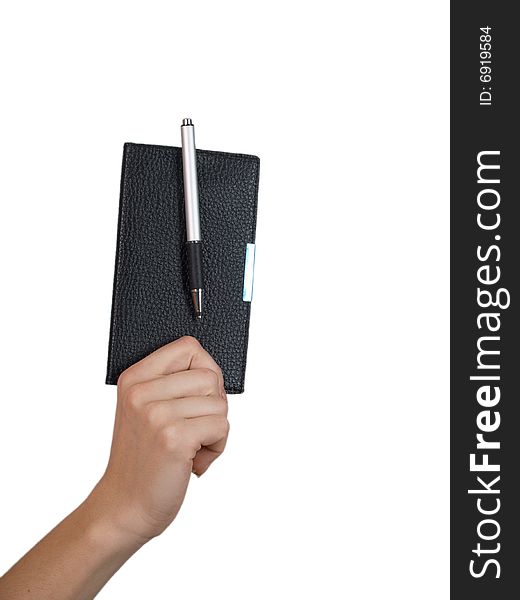 The female hand holds a small notebook on a white background. The female hand holds a small notebook on a white background