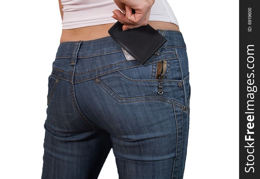 The female hand fills the pocket with a notebook of jeans. The female hand fills the pocket with a notebook of jeans