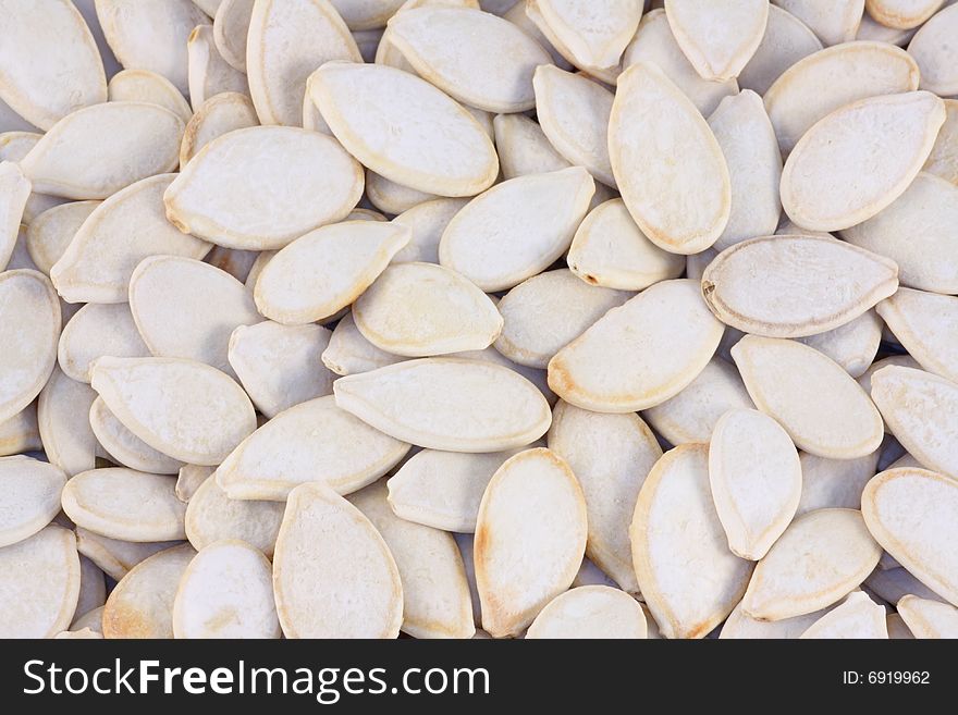 Cleaned and roasted pumpkin seeds as a Halloween background. Cleaned and roasted pumpkin seeds as a Halloween background.