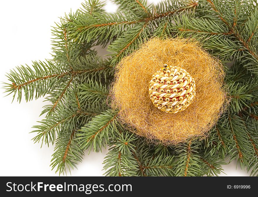 New Year's sphere in jack from gold on green fur-tree branches