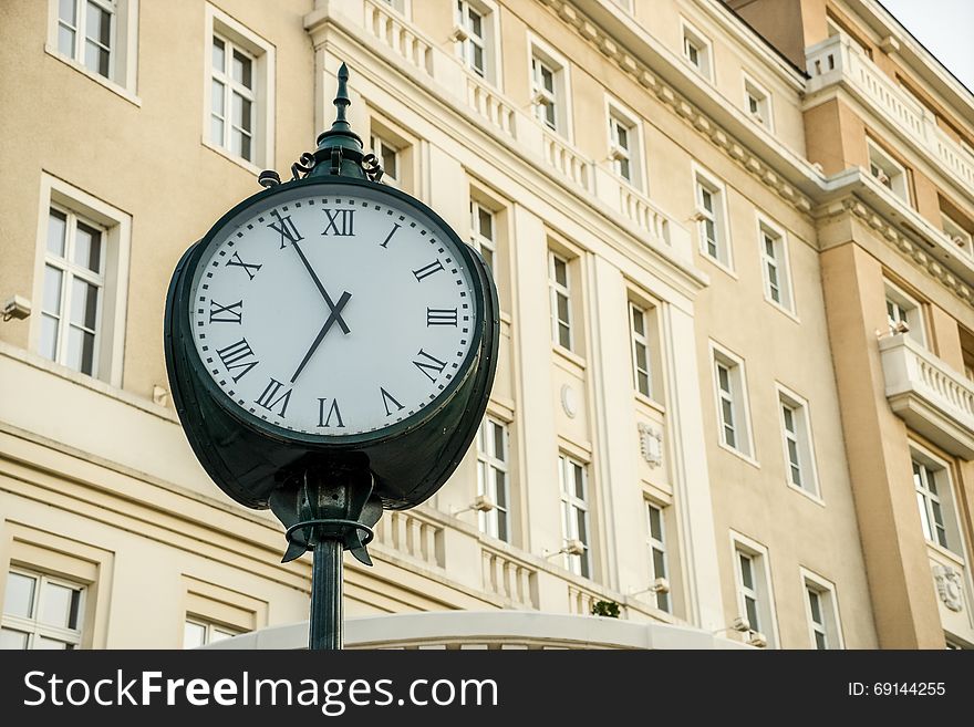 Clock in front of historical building. Clock in front of historical building