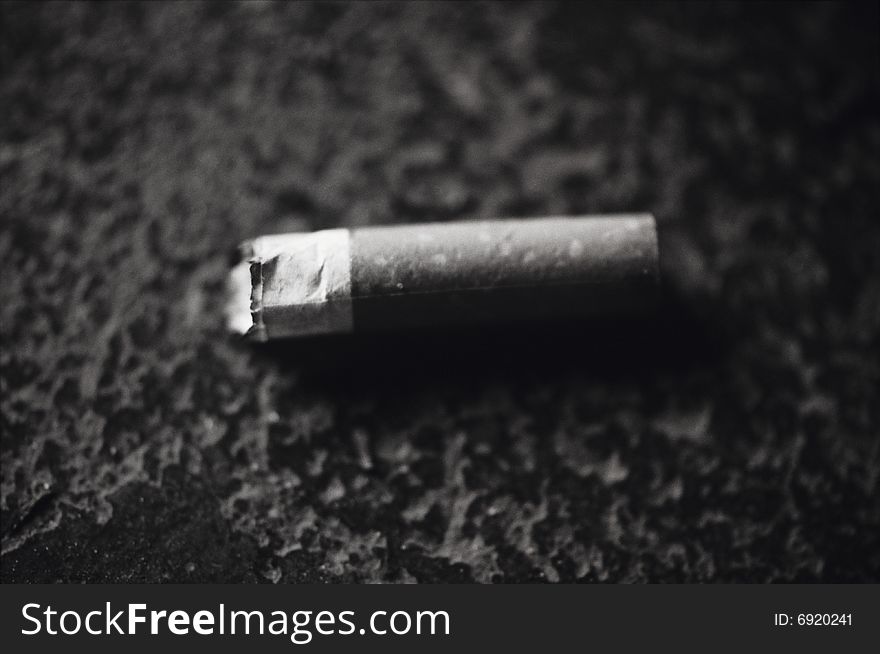 Black and white image of a used or smoked cigarette. Black and white image of a used or smoked cigarette.