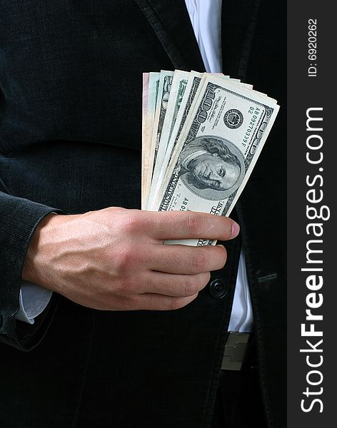 A man holding a stack of dollar banknotes. A man holding a stack of dollar banknotes