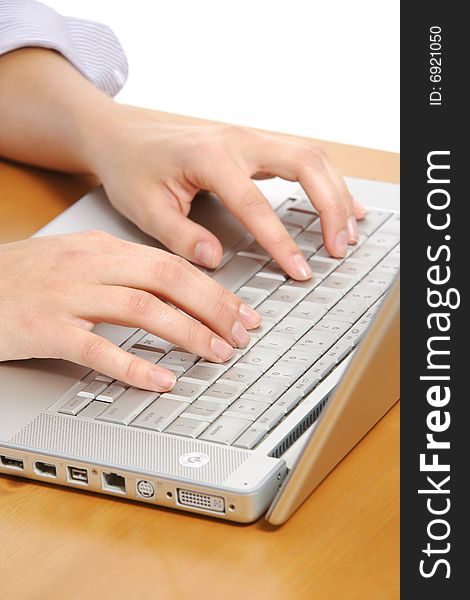 A person typing on a laptop keyboard