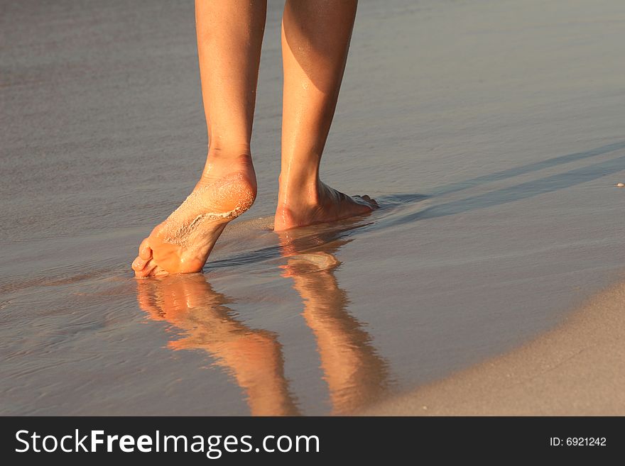 Female feet, walking on the caribbean beach. Female feet, walking on the caribbean beach