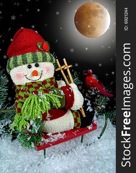 Christmas snowman on a sled under a full moon. Christmas snowman on a sled under a full moon.