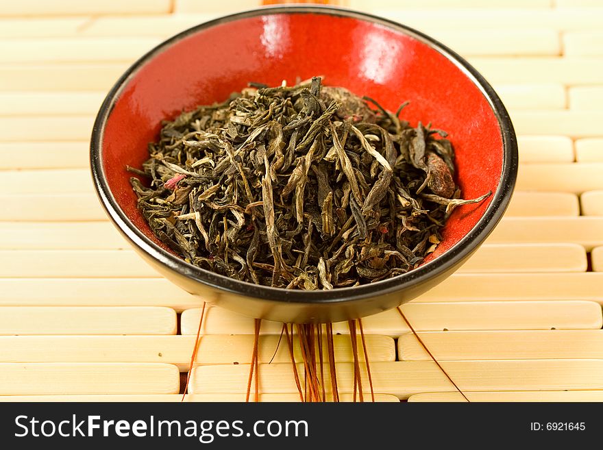 A fragrant herbal tea in a small red bowl. A fragrant herbal tea in a small red bowl.