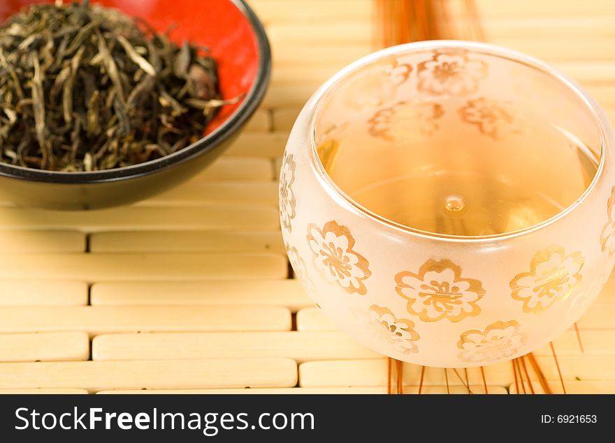 Pouring tea into an ornamental clear cup