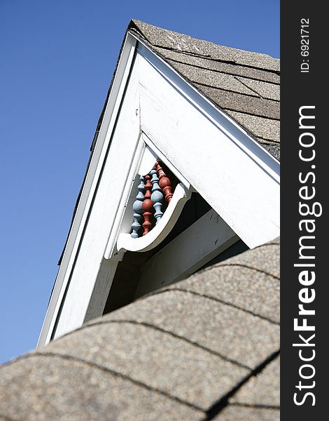 Roof dormer with blue and red design with white wood trim