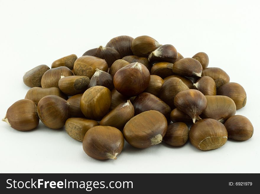 Brown chestnuts isolated on white background