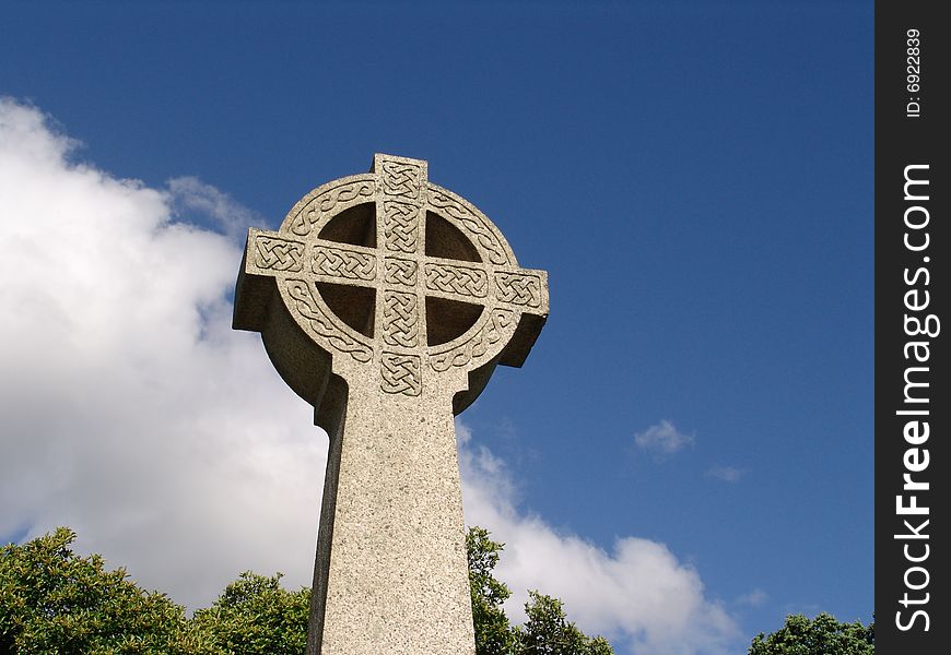 Ancient stone carved Celtic cross reaching skyward in Llandinam, Wales. Ancient stone carved Celtic cross reaching skyward in Llandinam, Wales