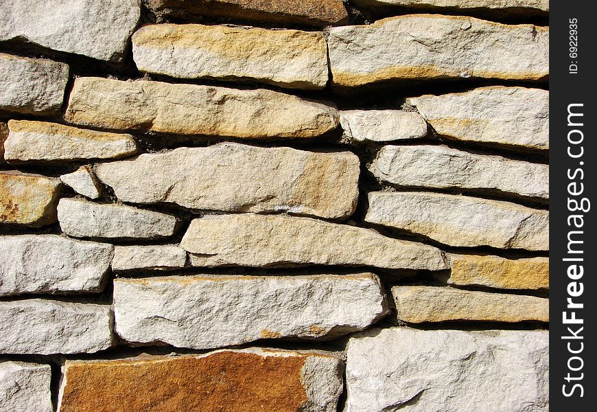 Irregular brick wall with various tint and forms of brick