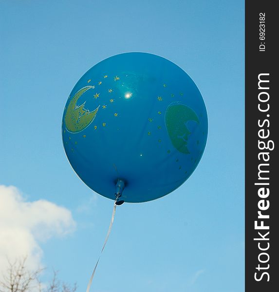 Blue ballon in the autumn sky. A ball is fastened a ribbon. Blue ballon in the autumn sky. A ball is fastened a ribbon.