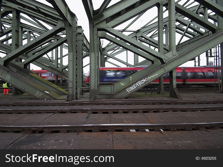 Man, Train and Bridge.
Hohenzollern Bridge in Cologne, Germany.