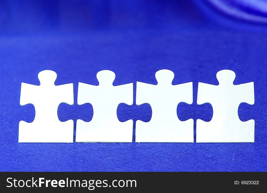 White puzzles isolated on a blue