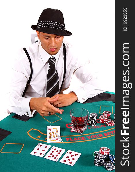 Young poker player is tossing his cards with a hat and stylish suit. Isolated over white background. Young poker player is tossing his cards with a hat and stylish suit. Isolated over white background.