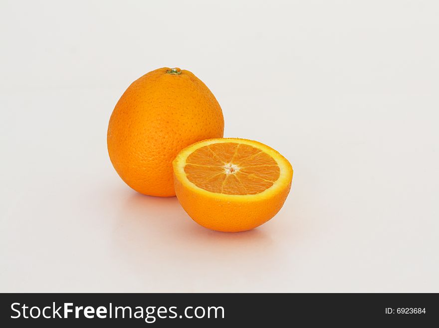 One and a halfe oranges on a white background. One and a halfe oranges on a white background.