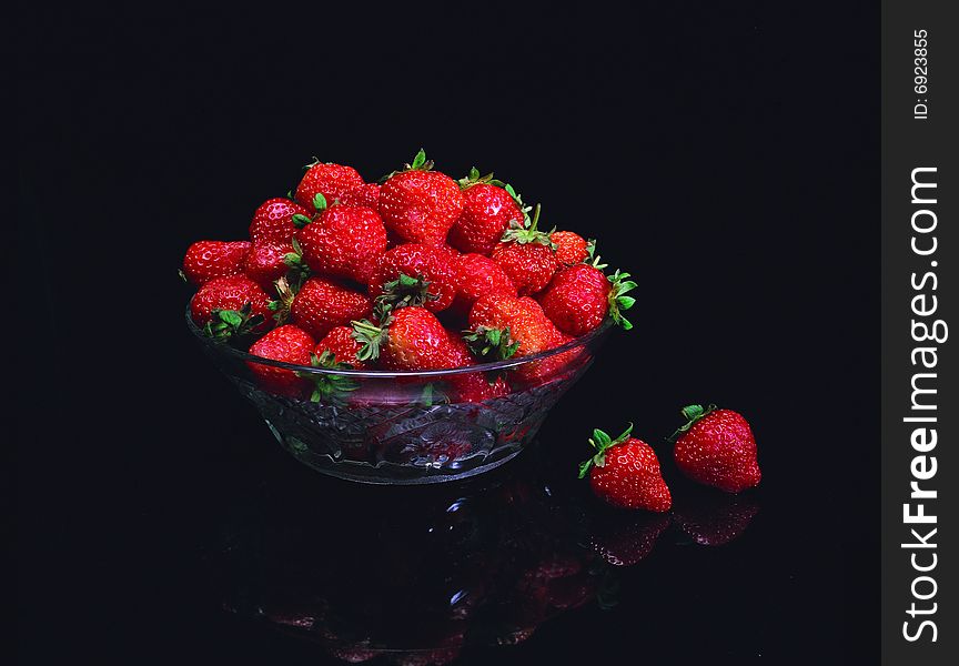 Red strawberry against black background