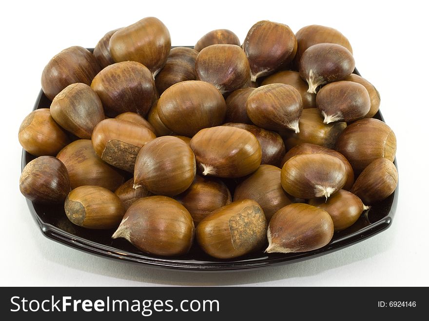 Chestnuts on dark plate isol