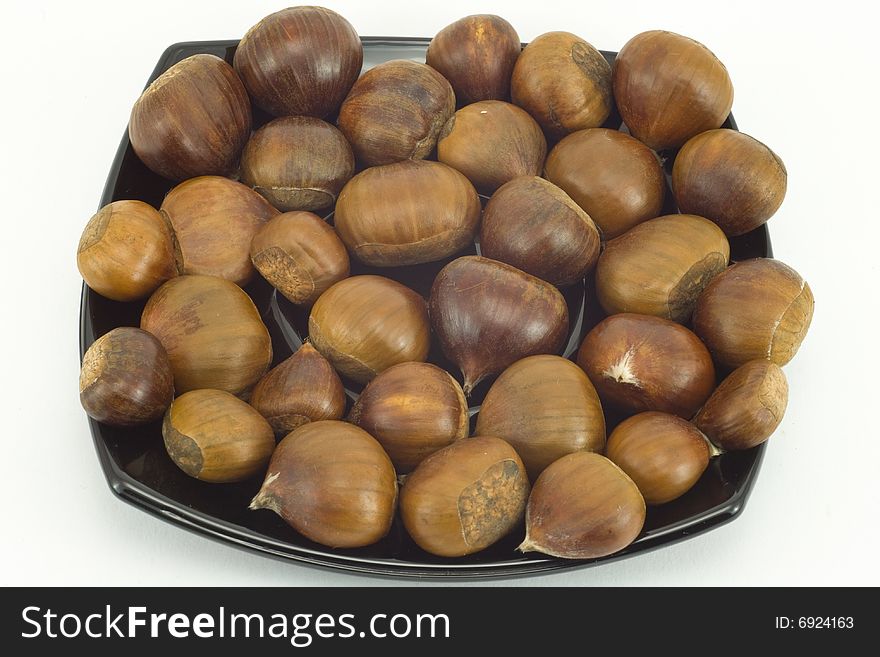 Chestnuts On Dark Plate Isol