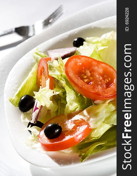 Fresh vegetable salad with tomato, onion, olive and lettuce. Fresh vegetable salad with tomato, onion, olive and lettuce