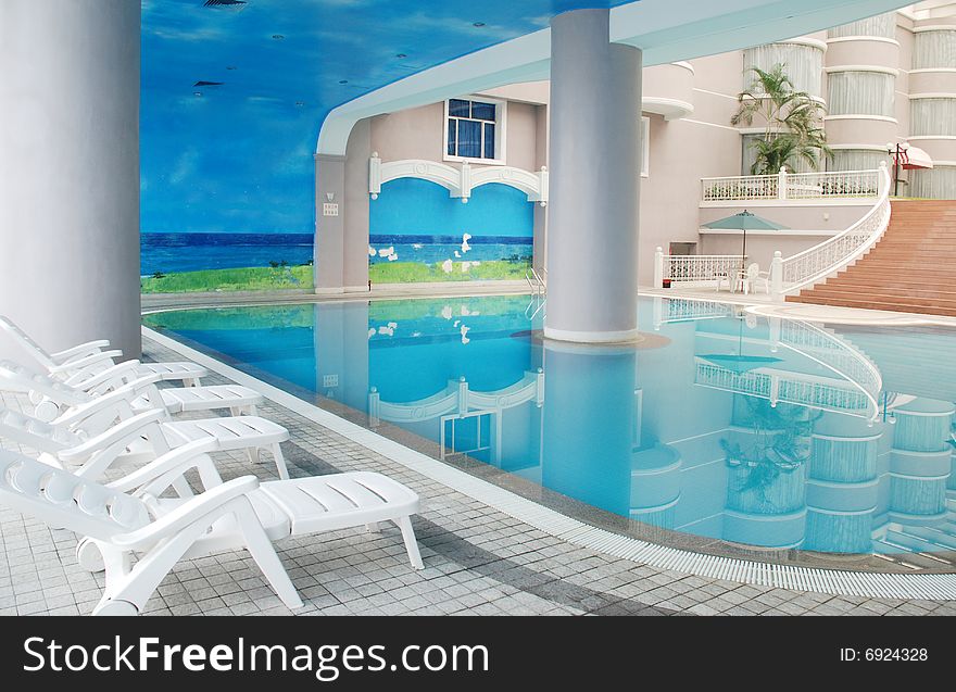 The indoor swimming pool in a hotel patio. The indoor swimming pool in a hotel patio.