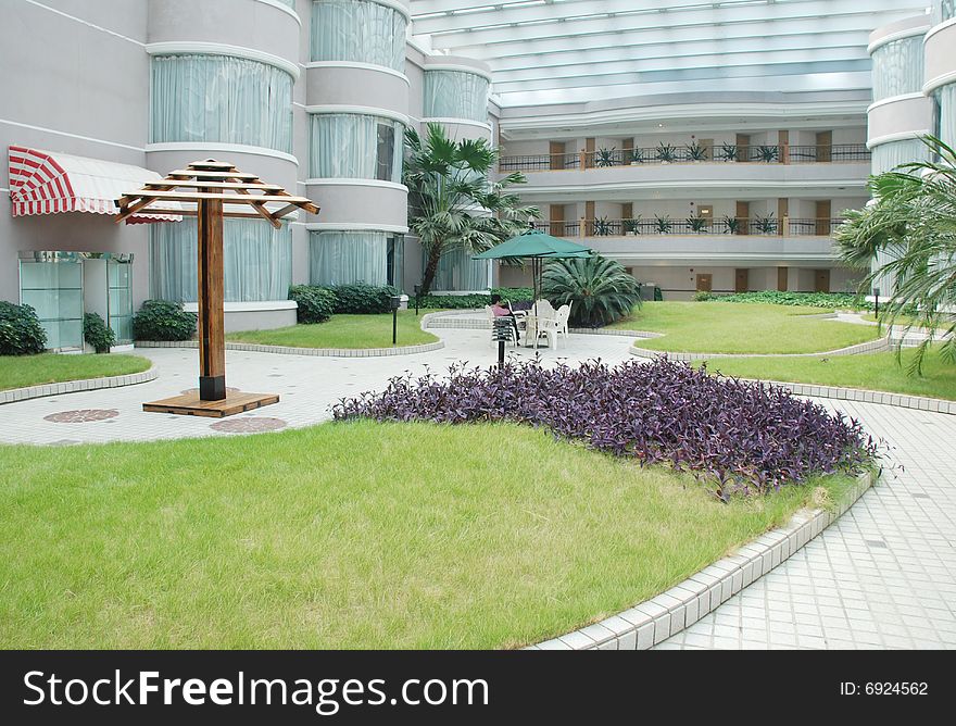 The indoor garden in a resort hotel patio with glass roof.