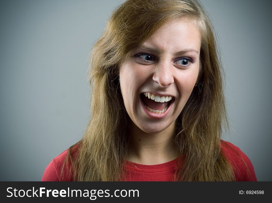Portrait of young screaming girl.