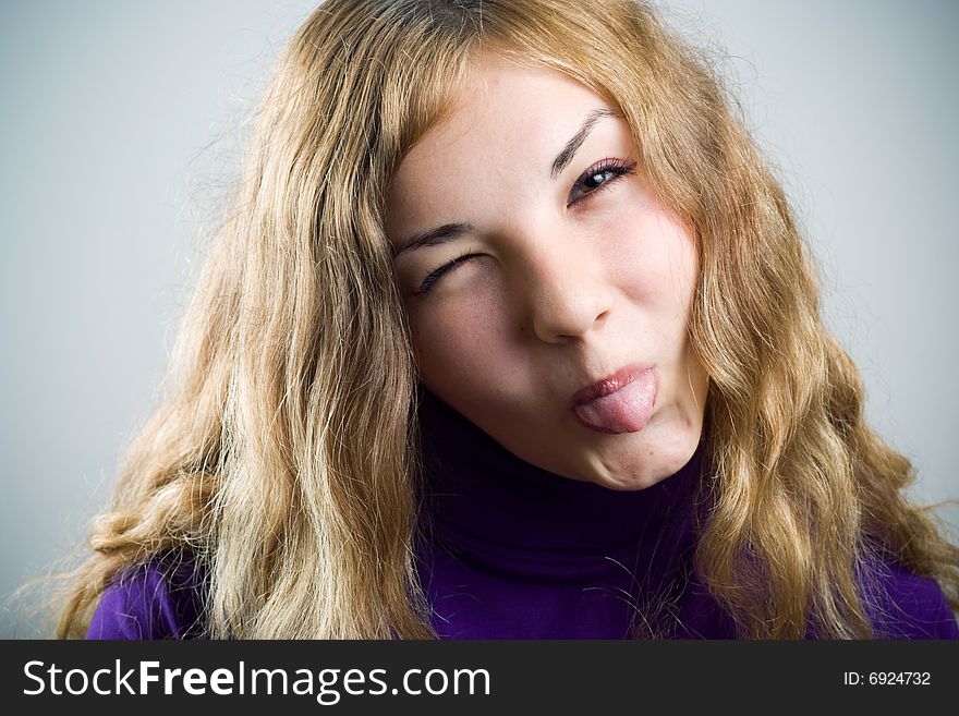 Girl put out tongue and wink. Girl put out tongue and wink.