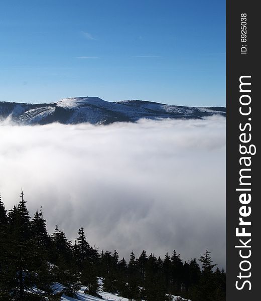 Winter mountains scenery with mist