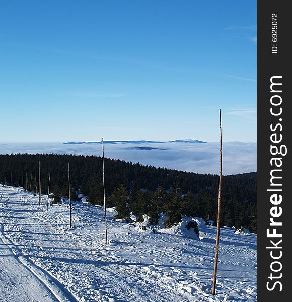 Winter mountains with mist and forest