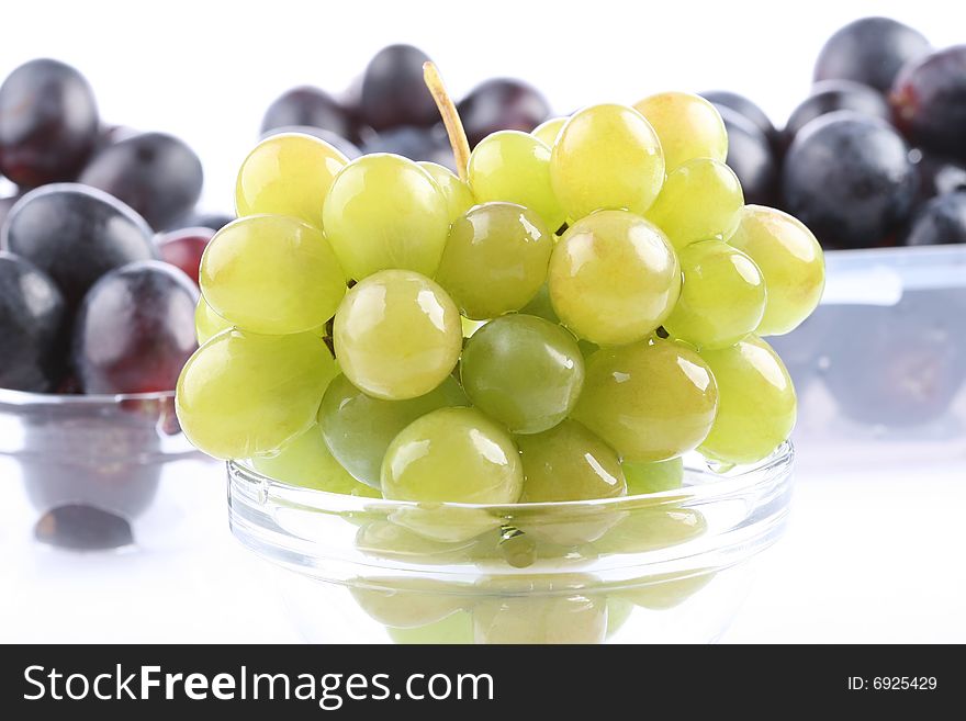 Closeup of delicious white grape with red grapes in the background. Closeup of delicious white grape with red grapes in the background