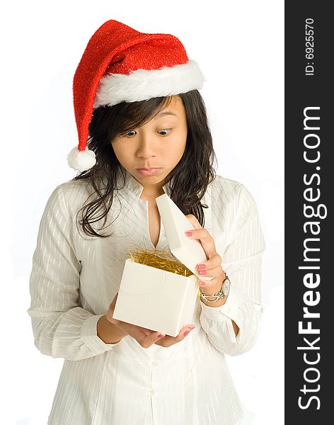 Asian teenager girl peeking hesitantly as she opens a straw-filled Christmas gift box. Asian teenager girl peeking hesitantly as she opens a straw-filled Christmas gift box.