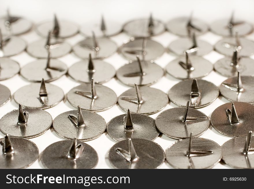 Rows of sharp steel thumbtacks as a background (vintage style)