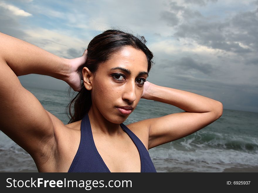 Young female with her arms behind her head. Young female with her arms behind her head
