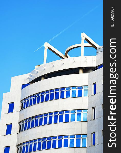 Modern building with reflection of blue sky on windows. Modern building with reflection of blue sky on windows