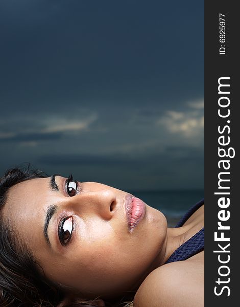 Headshot of a woman laying down and looking at the camera. Headshot of a woman laying down and looking at the camera