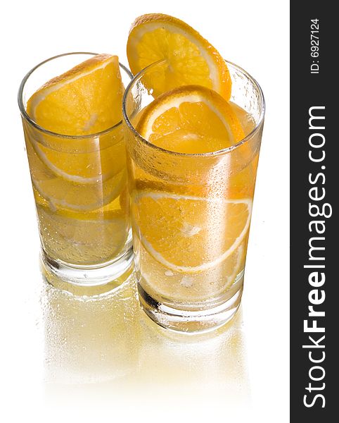 Two glasses of lemonade with orange and lemon. Two glasses of lemonade with orange and lemon