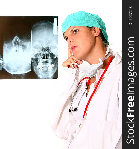 A young female doctor with a x-ray in the background and a stethoscope around the neck! Isolated over white. A young female doctor with a x-ray in the background and a stethoscope around the neck! Isolated over white.