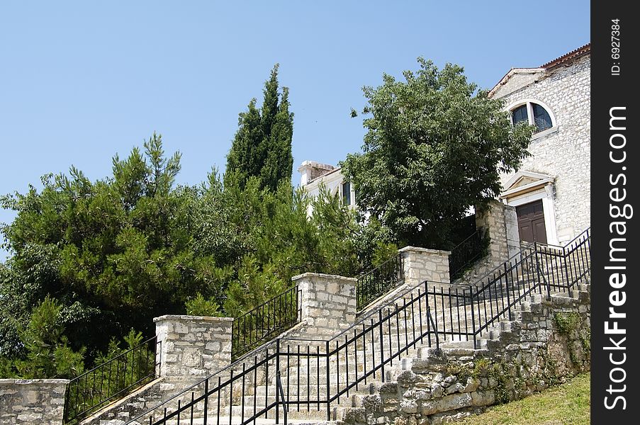 Photo of grand stone staircase with trees at the background. Photo of grand stone staircase with trees at the background