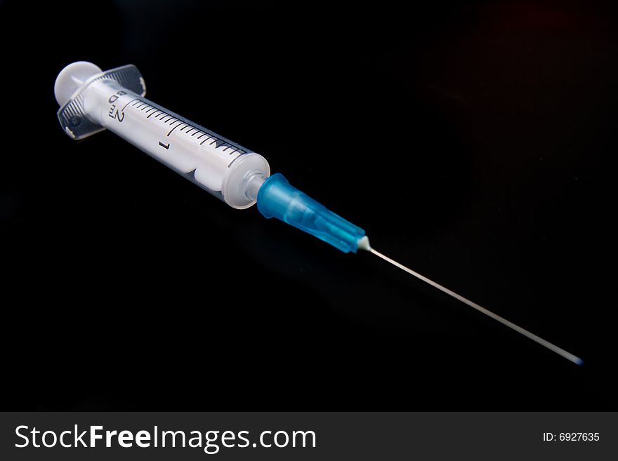 Medical Syringe On Black Background