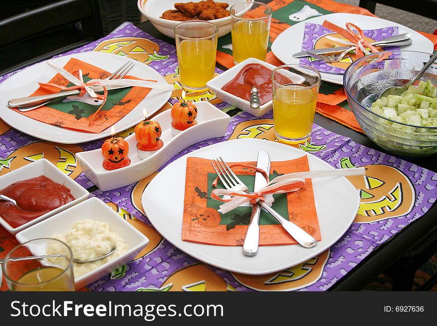 A halloween table with decorative table ware
