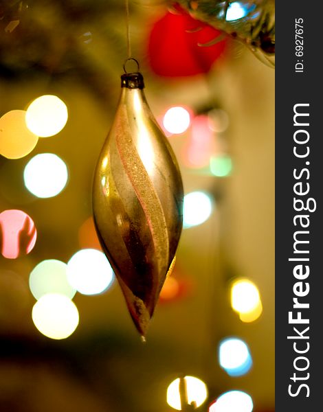 Christmas background with golden globe and tree lights in soft focus. Christmas background with golden globe and tree lights in soft focus