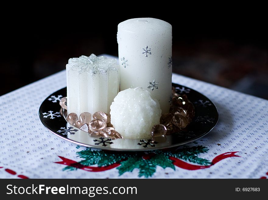 Christams table decorated with three white wax candles. Christams table decorated with three white wax candles