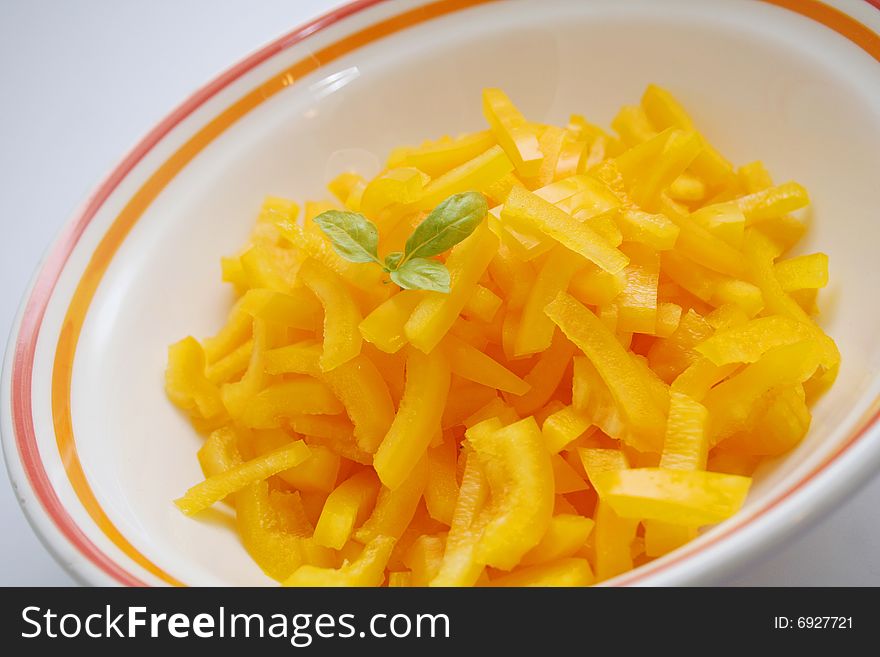 A fresh salad of yellow paprika with basil